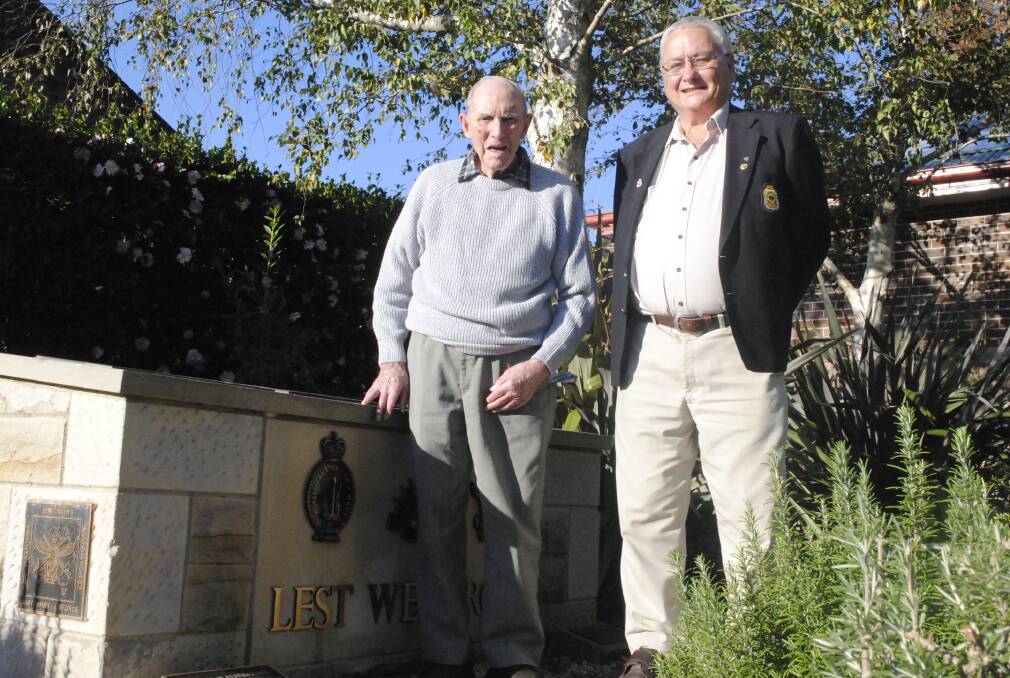 WWII veteran Arnold Sheedy and Bundanoon RSL sub-branch branch president Lee Borradale pause at the Bundanoon Cenotaph. Mr Sheedy, 93, is the branch's senior member. Photo by Josh Bartlett