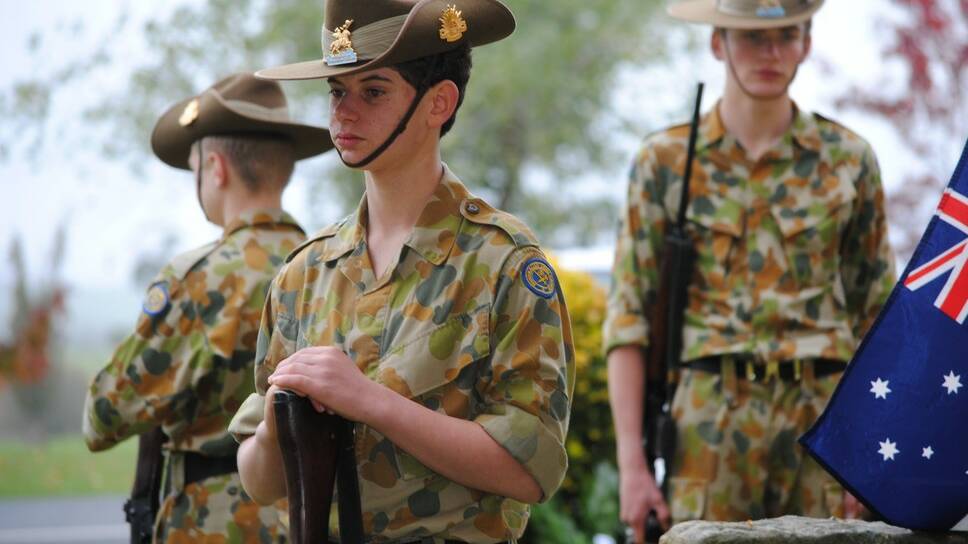 Young Ziad Hadba from the Chevalier College Cadet unit assemble around the Cenotaph at Sutton Forest War Memorial. 