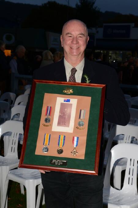 Victor Fitzhenry proudly displays the medal of his granfather, James Fitzhenry who served in World War I and II.