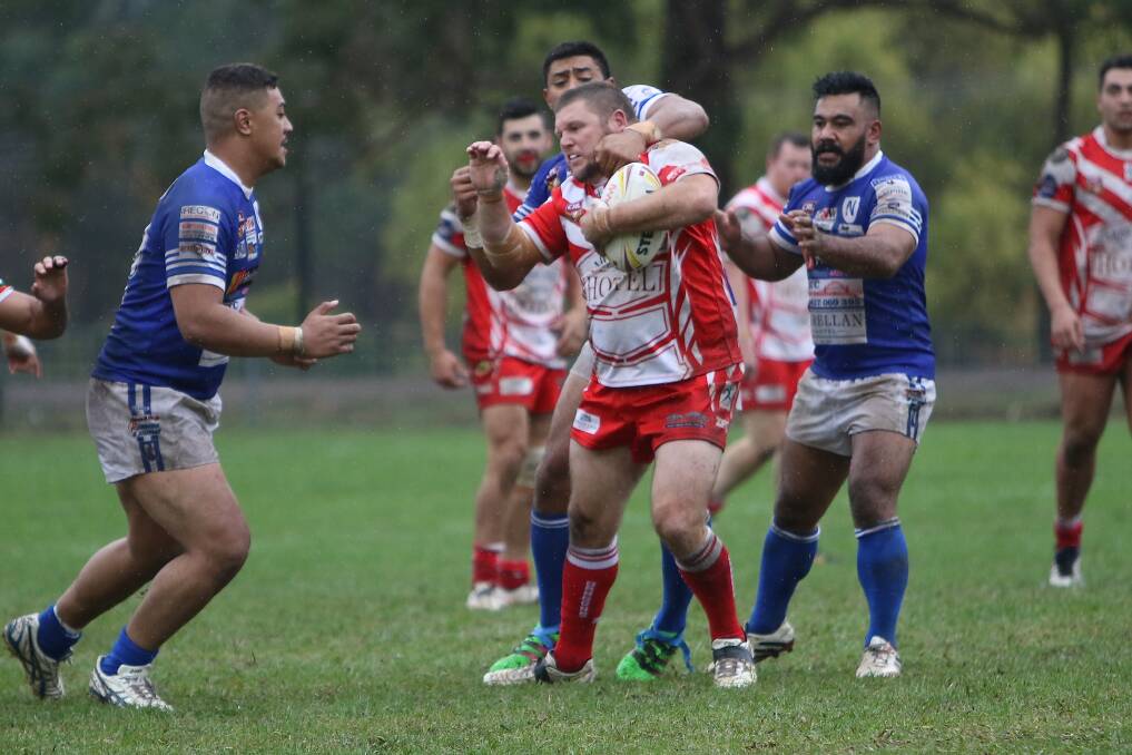 Moss Vale forward Robbie Payne battles with a group of Narellan players during a recent game. Photo by Daniel Bennett