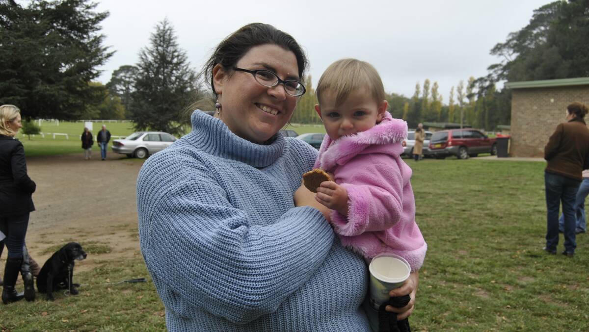 Nancy Lovato with daughter Delfina Lovato (18 months) biting into an Anzac cookie at Exeter. Photo by Dominica Sanda