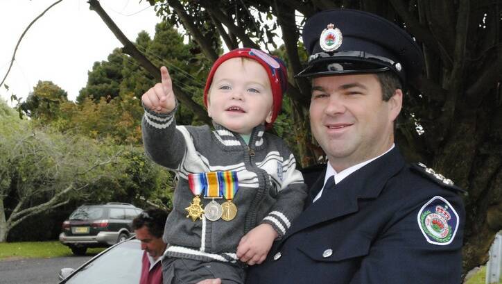 Russell and his son Josh, 2,  Moore wears his great great grandfathers medals who served in the battalion of Gallipoli.