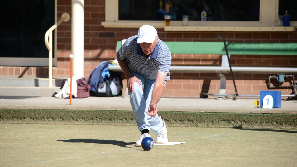 Jim Neeley watches the bowl from his hand to the green.