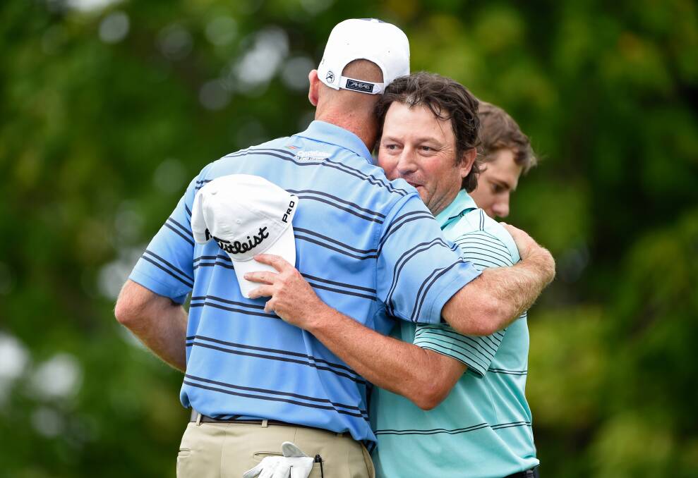 South African golfer Tim Clark (left) is congratulated by Jim Furyk during the final round of the RBC Canadian Open. Photo: FDC