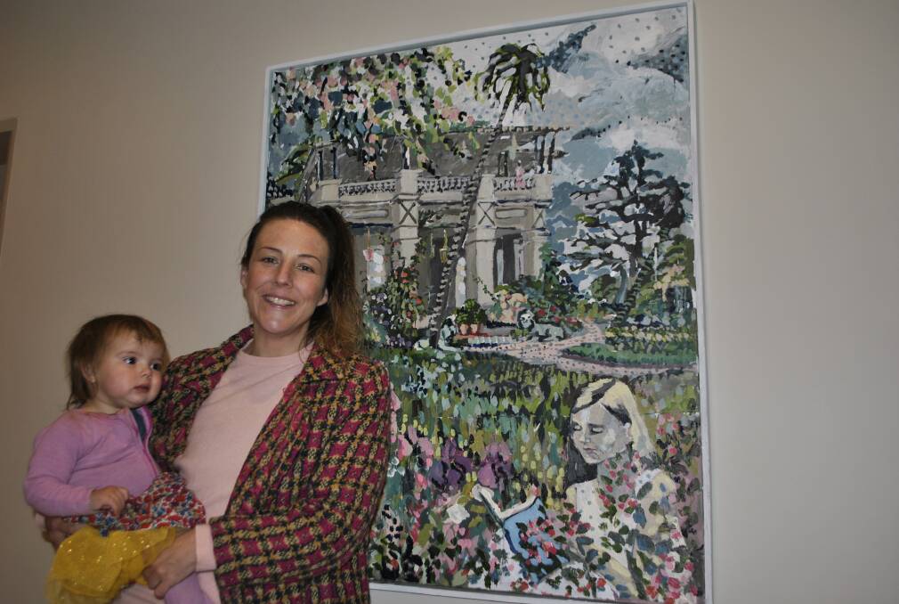 Zoe Young (holding Lucy, 18 months) with her painting 'Childhood Dreams' which she donated to the maternity ward at Bowral District Hospital. Photo by Claire Fenwicke