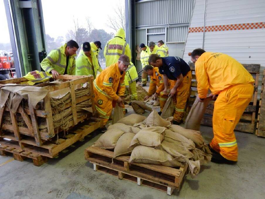 Local emergency services personnel prepare sandbags to distribute across the Highlands on Sunday. Photo by Leonie Knapman