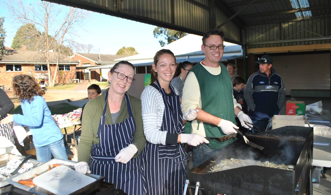 Parents and citizens association members Sandra Pryor, Emma Isedale and Andrew Ward cooked up a storm at the Mittagong booth. Photo by Claire Fenwicke