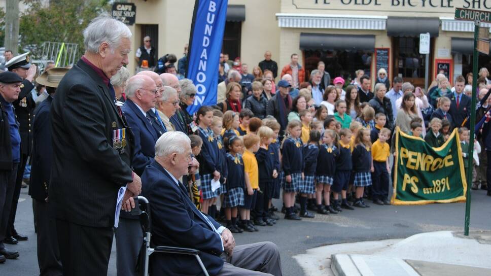 Ex-servicemen, Bundanoon Primary School Students and other parade participants gather round the War Memorial for the Bundanoon Anzac Service. 