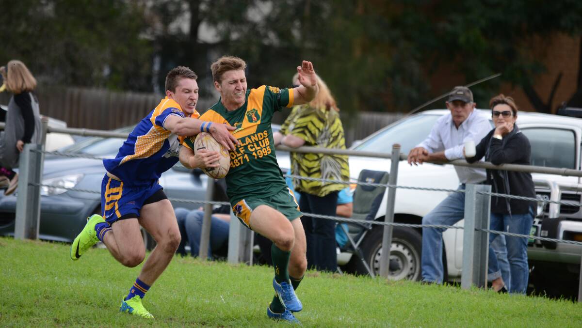 Bo Lander tries to get away from a Kangaroos defender during the game between the Mittagong reserve Lions and Campbelltown City Kangaroos. Photo by Roy Truscott