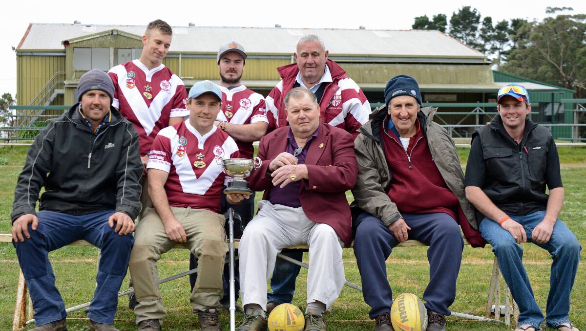 (front row) Brad Whatman, Doug Tilly holding the 1914 Premiership trophy, Bruce Noble proudly holding William Missingham's Premiership winning medal, John Whatman, Phillip Whatman, (back row) Clay Caines, Royce Harris and Nathan Waters. Photo by Roy Truscott