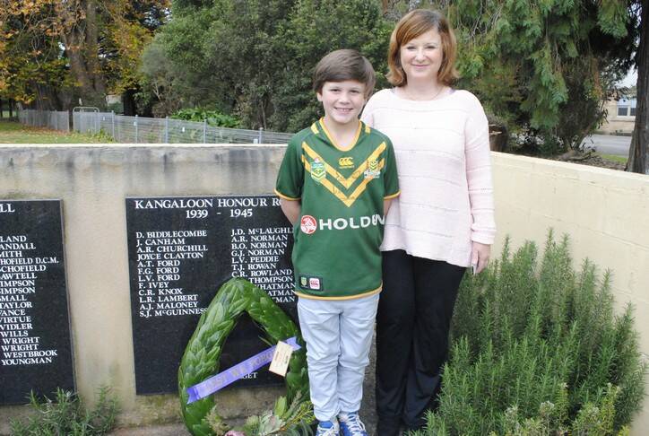 Jake Maloney stands at the Robertson War Memorial with his mother Margaret where his grandfathers name, A.J Maloney, is who served in the second World War.