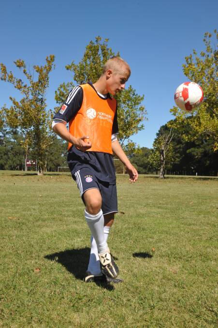 A Bowral United Soccer player warms up.