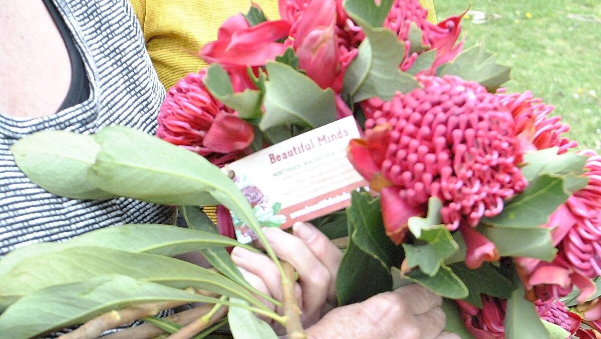 Co-founder of Beautiful Minds Sandra McDonald with a bunch of waratahs for sale. Photo Ainsleigh Sheridan