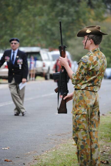 A Chevalier College cadet prepares for the Anzac March at Sutton Forest Service. 