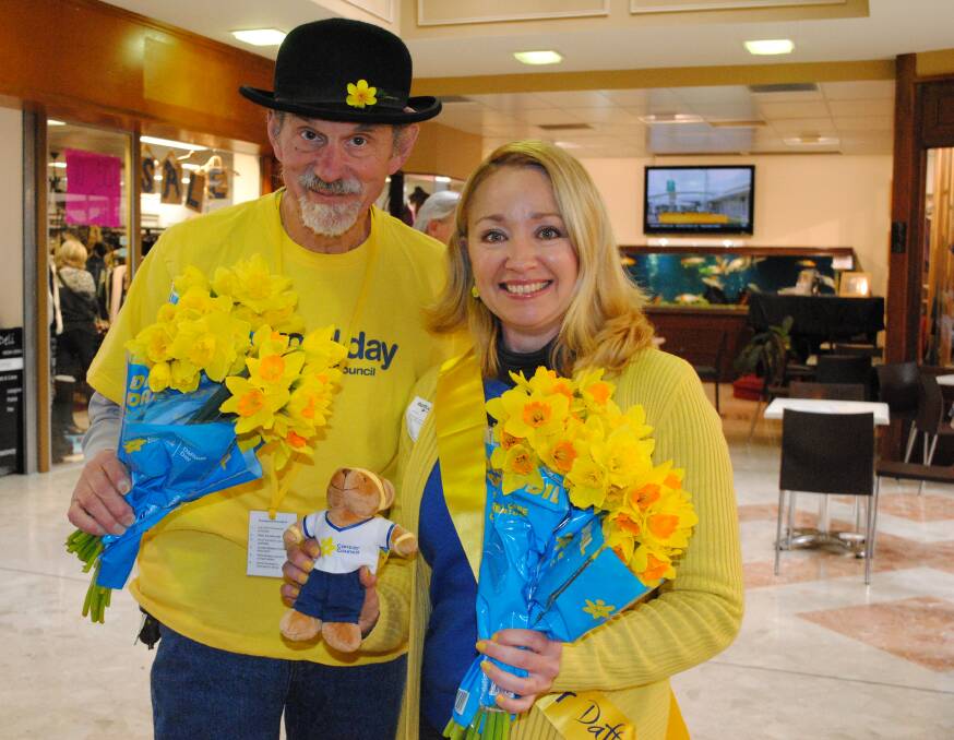 Cancer Council NSW volunteers John Cider and Samantha Slater sell Daffodil Day items in Springetts Arcade, Bowral, on Friday. Photo by Josh Bartlett