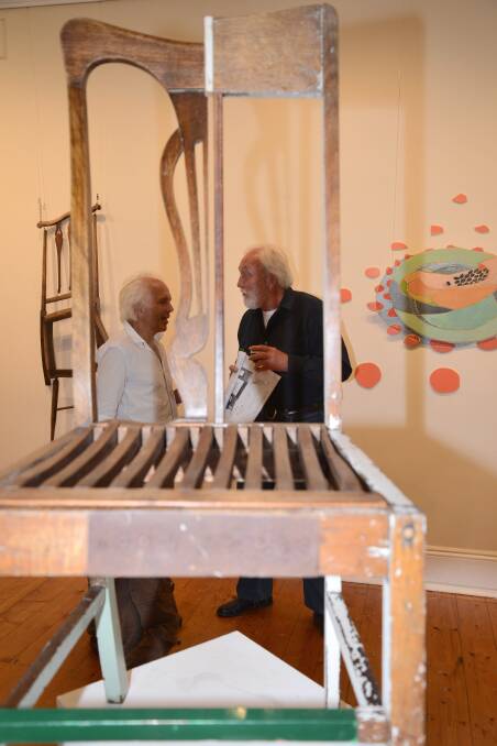 Discussing the artworks on display were Mick Fahl and David Morgan.
Photo by Roy Truscott