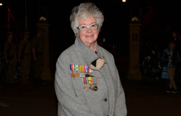 Helen Gates proudly wears the medals of her husband John Gates who served in World War II.