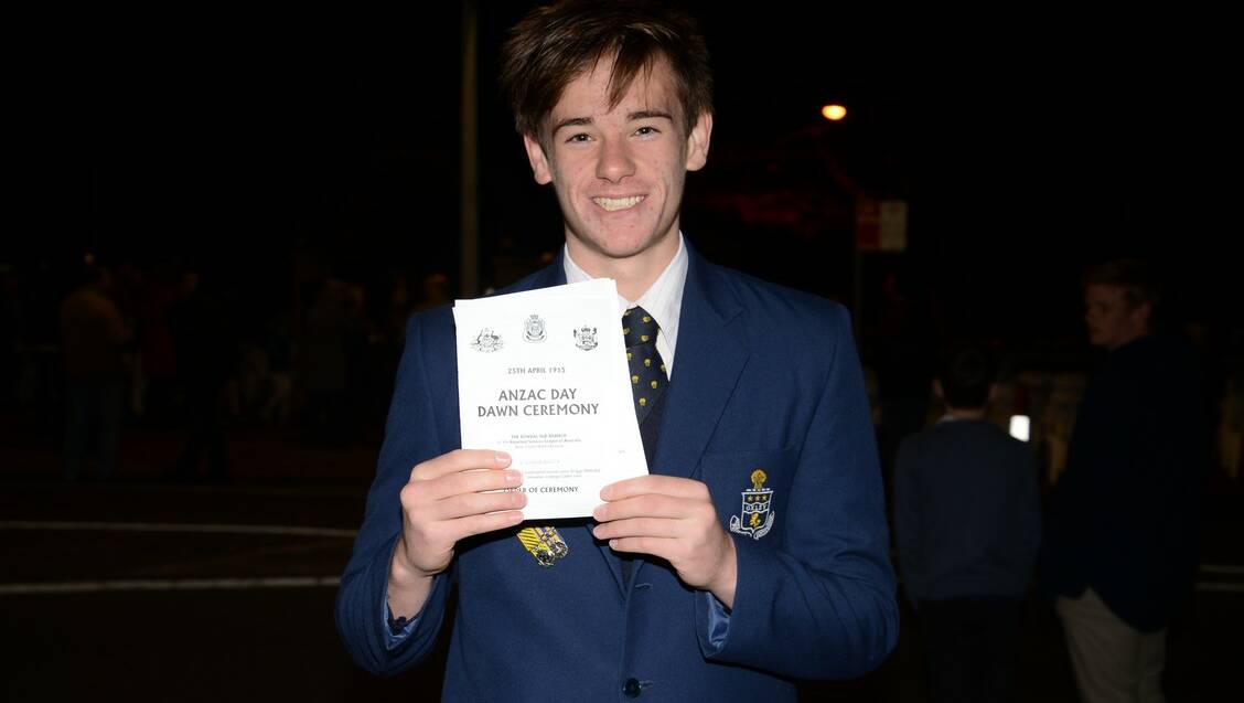 Edward Bowyer, 16, from Oxley College hands out programs for the Bowral Dawn Service.