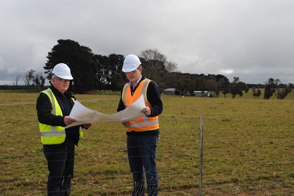 Greig Duncan and Alex Pauza looking at plans for Hume Coal's underground coal mine.  Directly behind them, behind the trees, is where the coal preparation plant will be built. Photo by Dominica Sanda