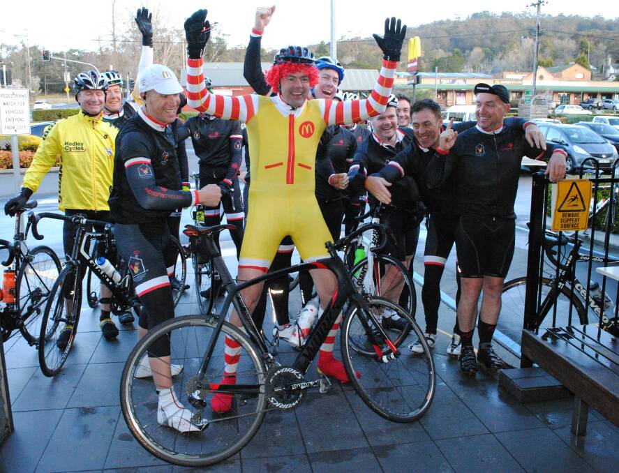 Tony Aichinger, dressed as Ronald McDonald, and crew celebrate finishing Thursday's leg of the Ronald McDonald House Charities Ride for Sick Kids Riverina from Queanbeyan to Mittagong McDonald's. Photos by Josh Bartlett 