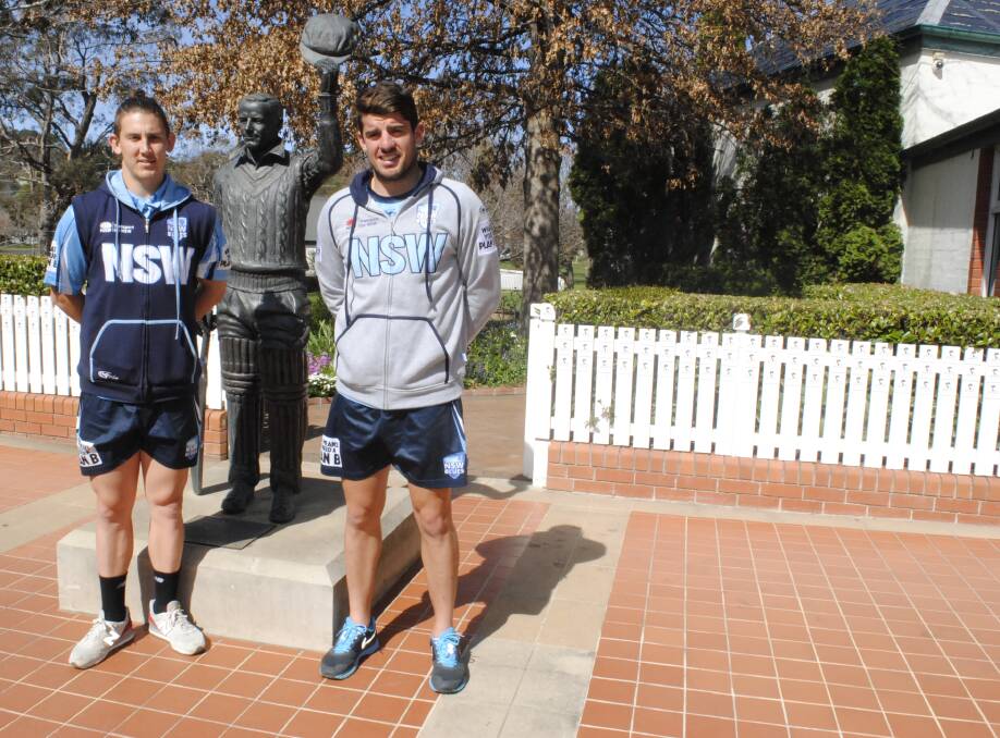 Professional cricketers Nic Maddinson and Moises Henriques stand in front of the Sir Donald Bradman statue at Bowral's Bradman Museum. Photos by Josh Bartlett