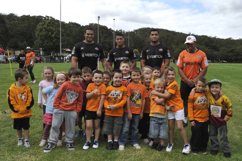 Children at the West Tigers clinic with their heroes yesterday. 	Photo by Roy Truscott
