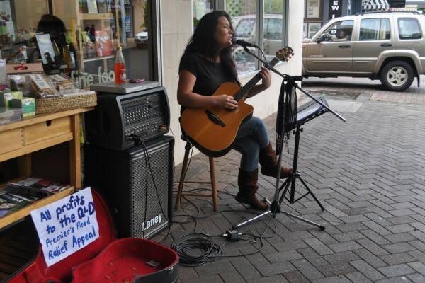 HELPING HEART: Bundanoon singer/songwriter Rosalind Chia grabbed her guitar and took to Corbett Plaza recently to raise $415.05 for the Queensland Premier's Flood Relief Appeal. Photo by Tahnae Goldsworthy