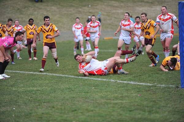 TRYTIME: Wille MacDonald fights his way over the line at Community Oval yesterday.