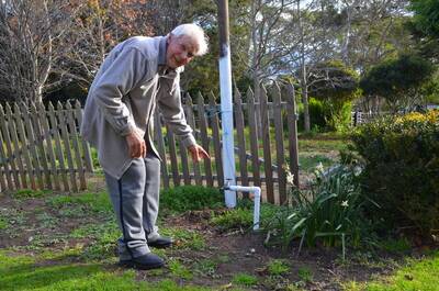 Medway resident Les Talbert points out the tap from which they get water from the Berrima Colliery. Photo by David Alexander