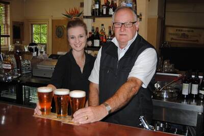 Burrawang Hotel owner Ed Woolfrey and bar staff member, Hayley Sheffield, toast three schooners to the top class success of the pub in the Sydney Morning Herald Good Food Pub Guide 2012.  Photo by Jackie Meyers