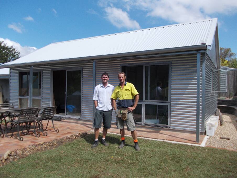Andrew Lemann with one of his helpers Daniel Jones in front of the 'Greeny Flat'. 	Photo by Megan Drapalski
