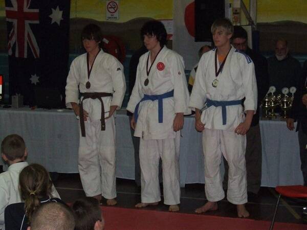 SOLID PERFORMANCE: Vaughn Edmunds (centre) collecting his silver medal at the recent Australian Judo Union’s National Championships.