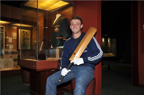 IN AWE OF BRADMAN: Phillip Hughes with the bat Sir Donald used to score his second highest test score, 304 against England in 1934. Photo by Roy Truscott