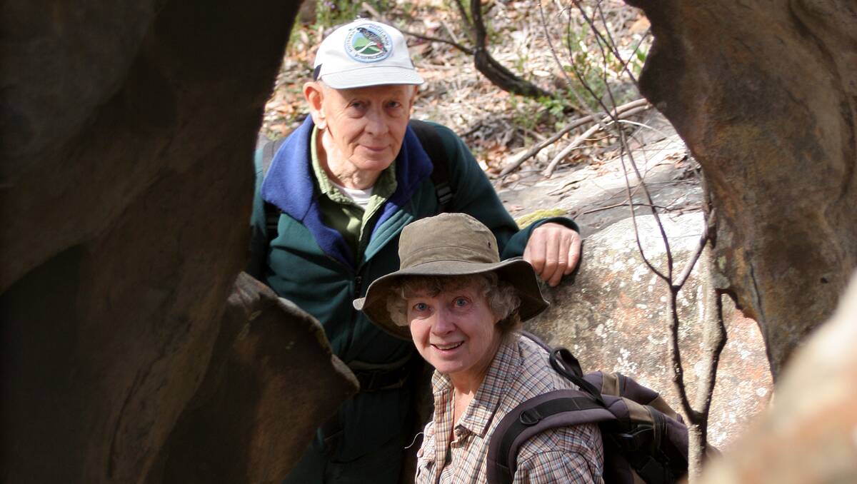 Well known Southern Highlands Bushwalkers committee members, Malcolm and Margaret Hughes, framed by one of the unique rock formations of the Caves Creek Walk. [Photograph by Sasha Baer 