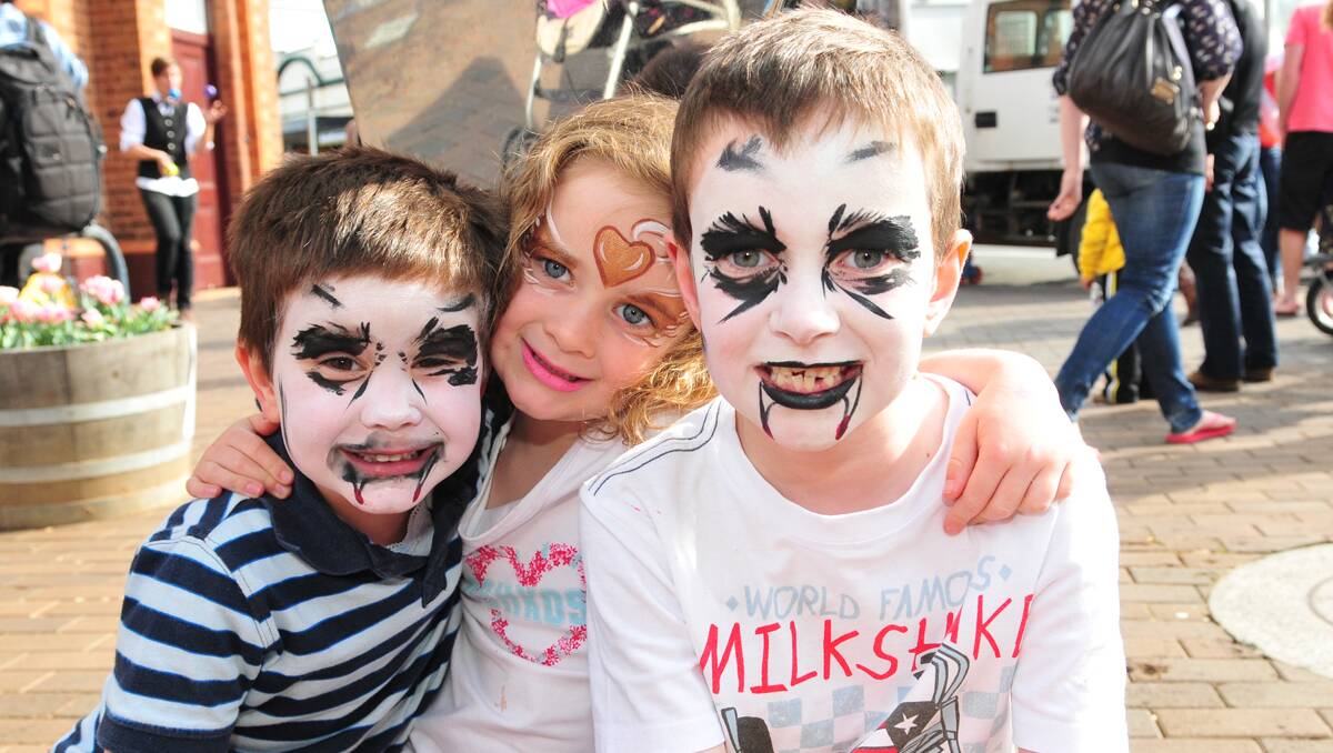 Putting on their best faces for Tulip Time is Matthew, Megan and Jack Loveridge.