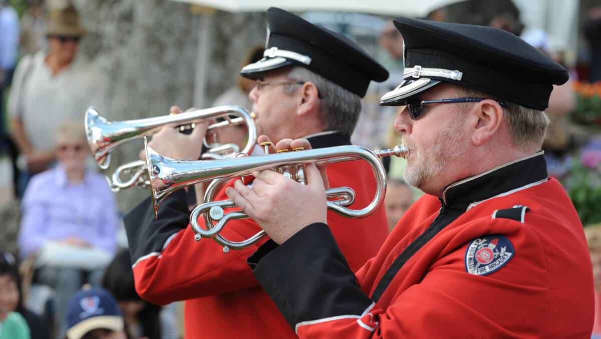 Members of the NSW Fire and Rescue Band playing in Corbett Gardens on Saturday.