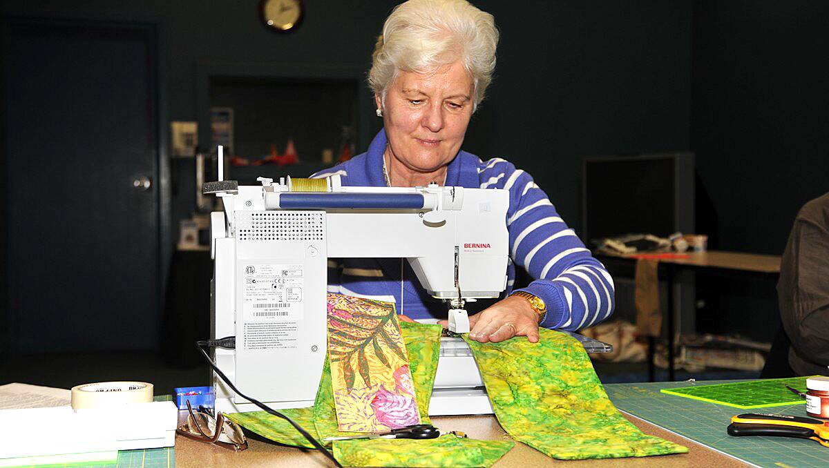 Robyn Sammons is all concentration as she runs a piece of trellis though the sewing machine.