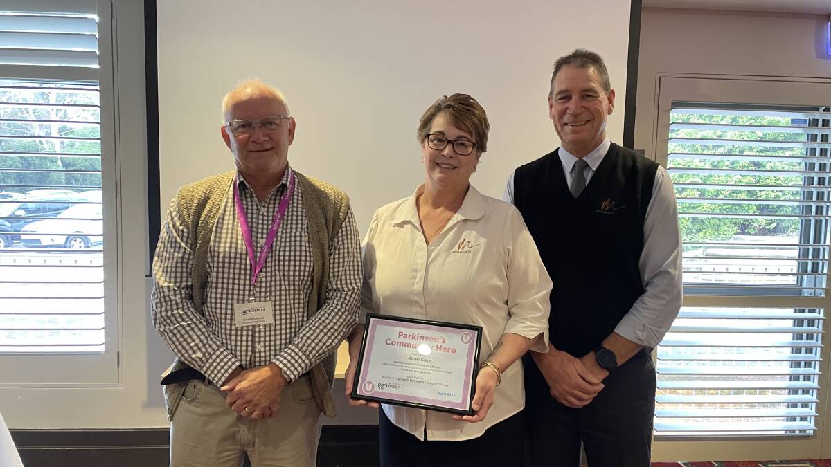 Brian Nowland (left) and Mittagong RSL general manager Craig Masden (right) stand with Parkinson's Community Hero Nicola Crisp (middle). Picture: Briannah Devlin
