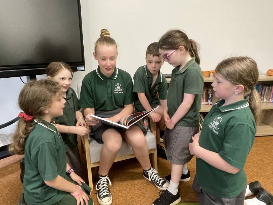 Sophia, Cora, Annabel, Rory, Bree and Lily love reading in the new library. Picture by Briannah Devlin. 