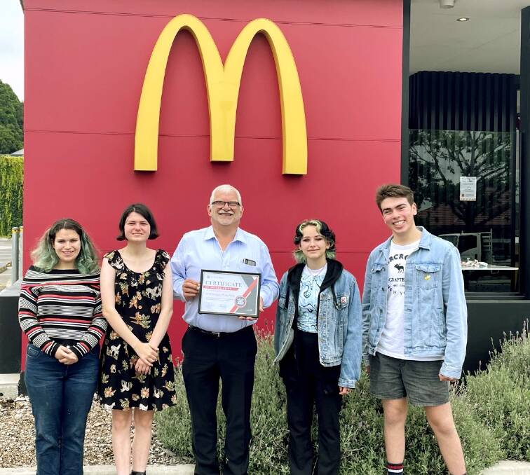 Left to right: Ivy, Milly, Jess and Zach presented Graham Marcolin (middle) with a certificate of appreciation for his ongoing support to the Wingecarribee Vocal Muster. Picture: Supplied 