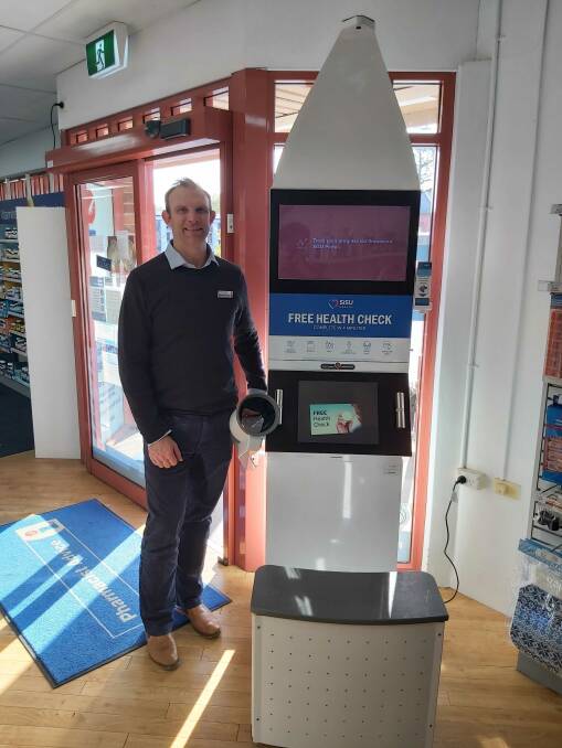Nick Knowles stands with the SiSu Health Station in his store. Photo: Supplied 