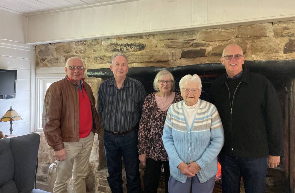 Jean (fourth from the left) and her children Russell Neeves, Warren Neeves, Kathryn Greenwood and Gregory Neeves inside Hatch Cottage near the fireplace. Picture: Briannah Devlin