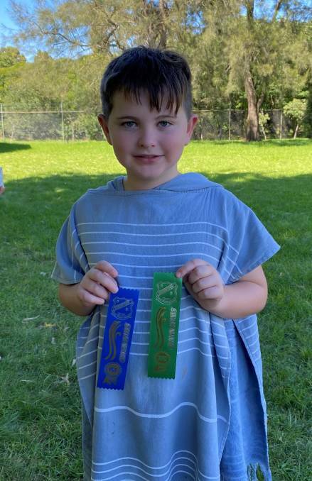 Joshua Moore showing off his ribbons from the Robertson Primary School Swimming Carnival Picture: Supplied 
