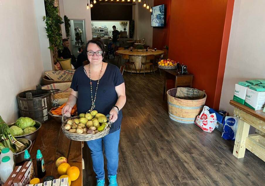 Coordinator of C3 Cares Rebecca Traynor with some of the available produce in their new space on Bong Bong Street. Photo: supplied
