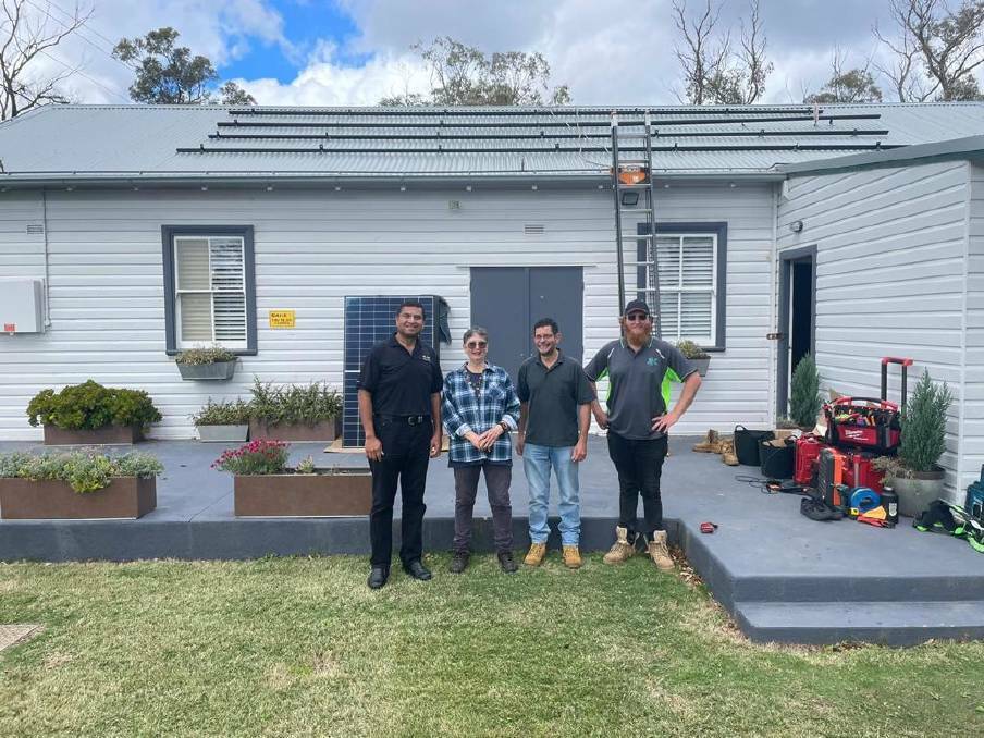 REC's Ryan Sequeira, president of the Balmoral Village Association Elizabeth Atkin and installers from Kik Connect. Photo: supplied
