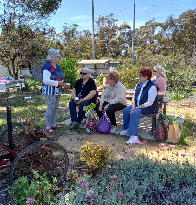 Locals gather around the railway table. Picture: Maryann Anderson 