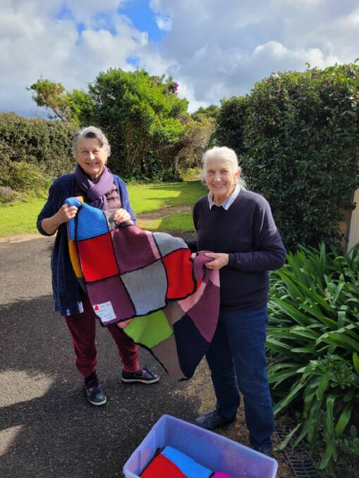 Lismore Evening CWA President Kerry Harvey was "delighted" when Southern Highlands Evening CWA member Jan Bell drove eight hand-knitted rugs up to Lismore. Picture: Supplied 