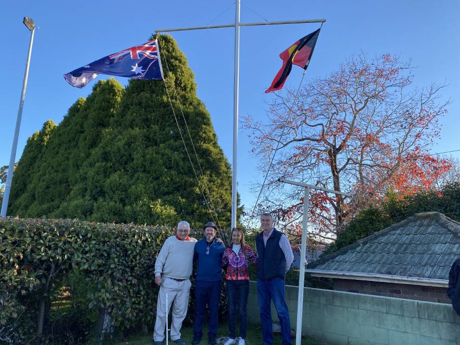 Lee Borradale and Gus Johnson raised the Australian flag while Aunty Trish Levett and Peter Elsemore raised the Aboriginal flag. Photo: Briannah Devlin. 
