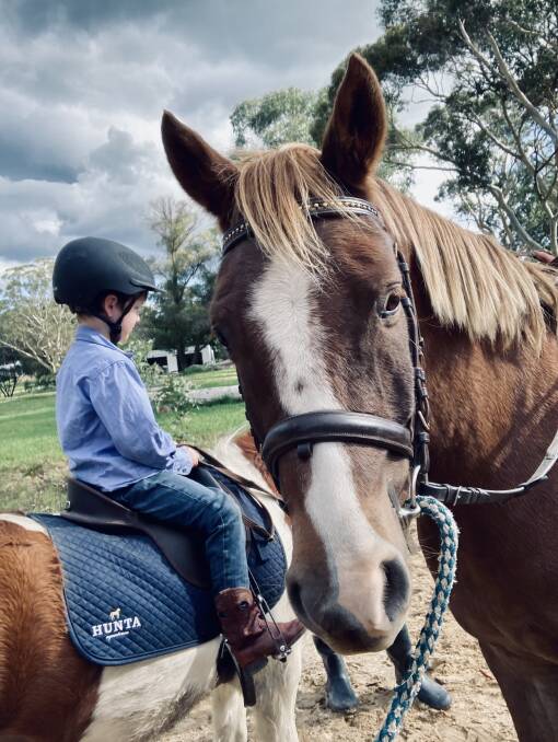Christo Galwey, three is riding Jimmy while Bolt watches. Picture: Tanya Galwey