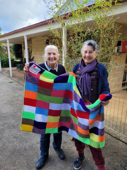 Lismore Evening CWA President Kerry Harvey (right) was "delighted" when Southern Highlands Evening CWA member Jan Bell (left) drove eight hand-knitted rugs up to Lismore. Picture: Supplied
